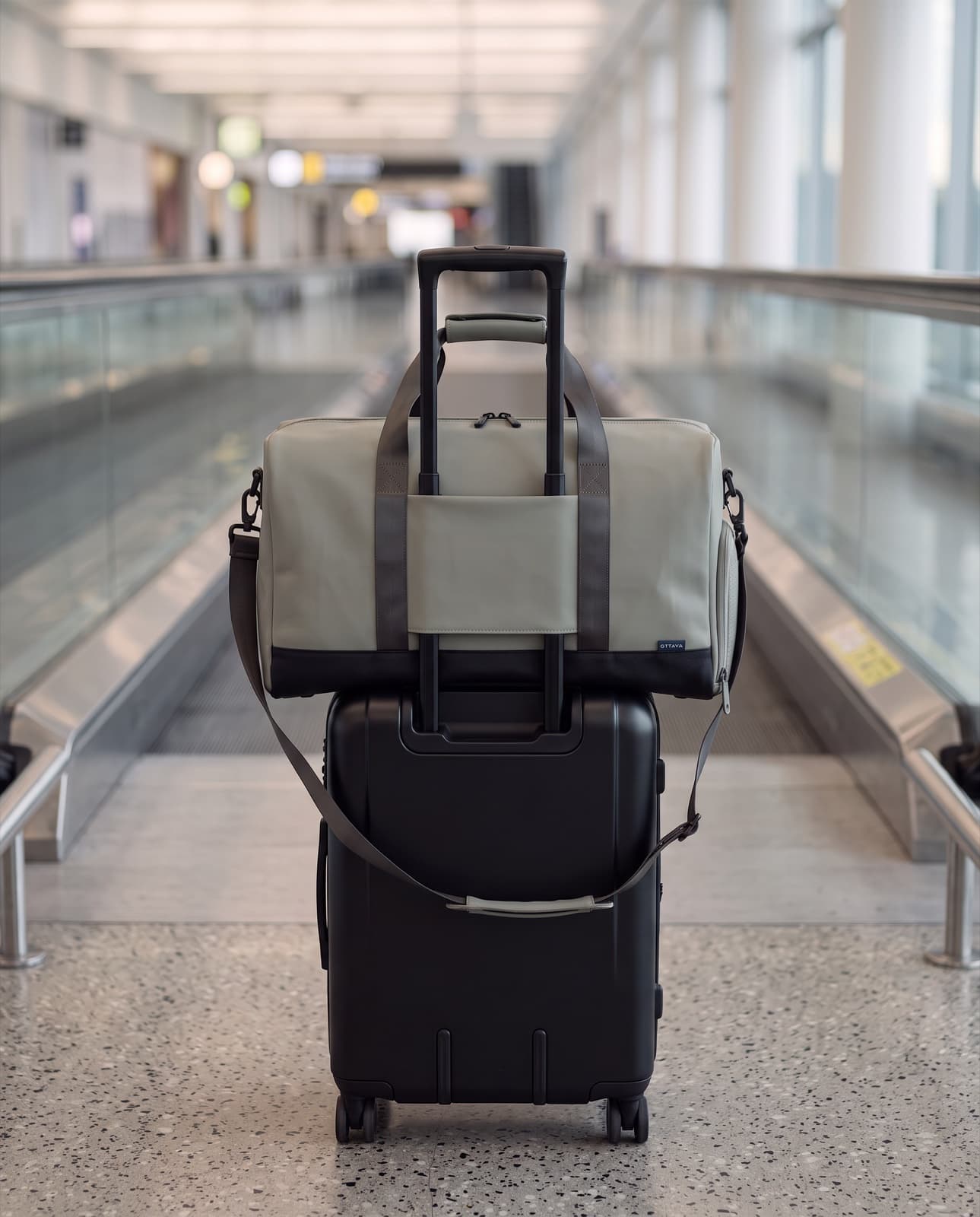 A duffel beside a departure gate window