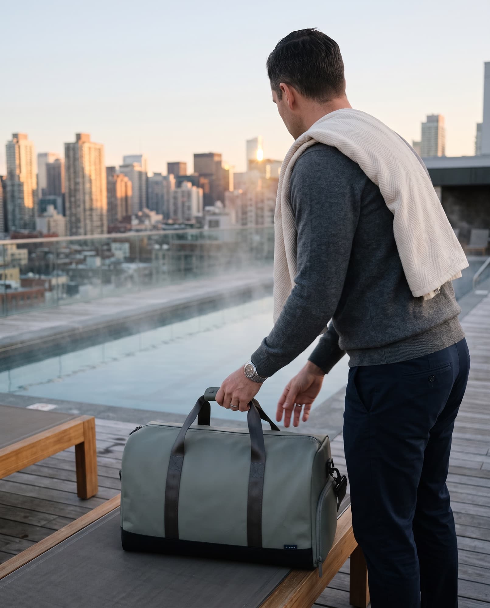 Duffel 50 beside a rooftop pool at dusk