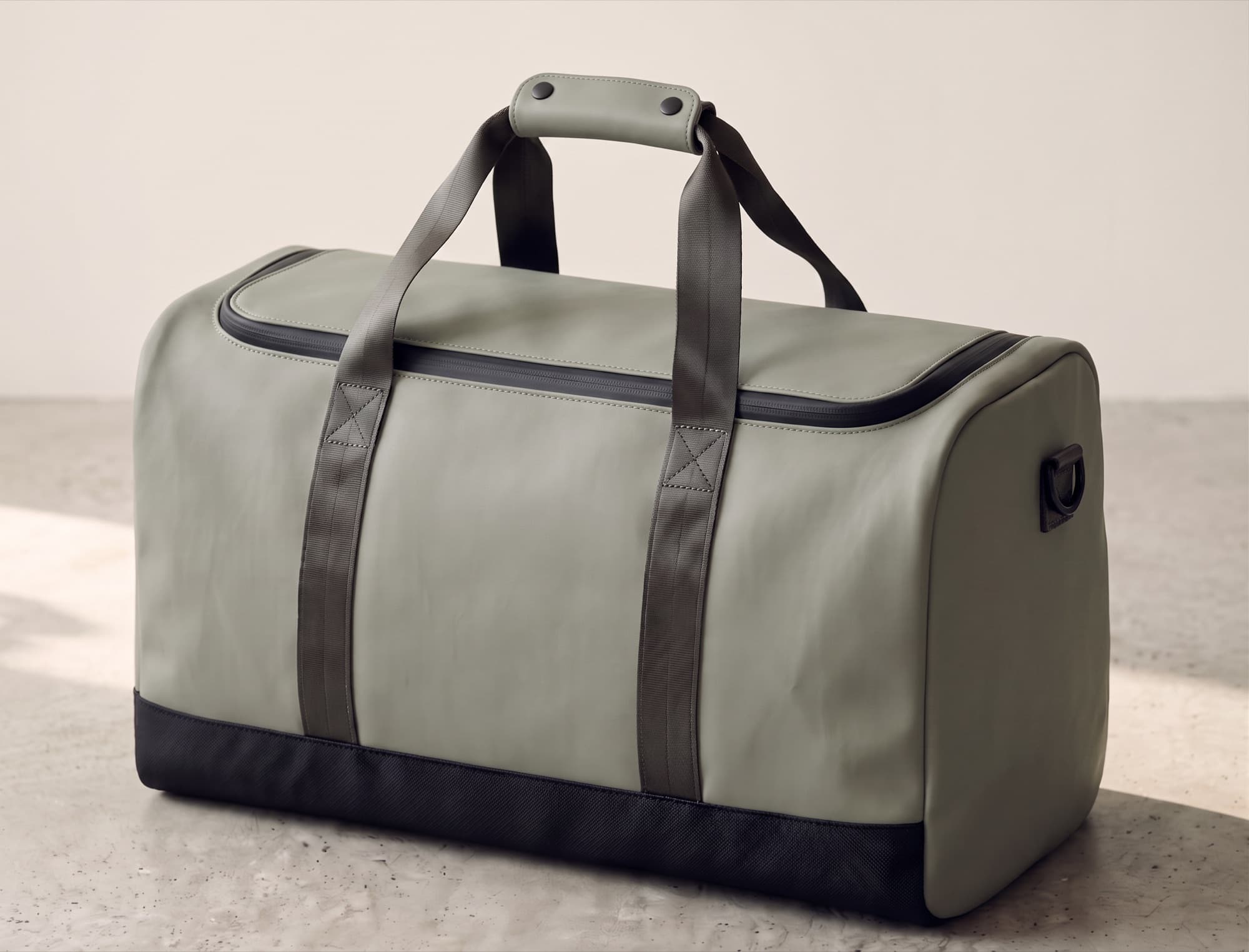 OTTAVA Duffel 50 in Fog Sage on a concrete floor