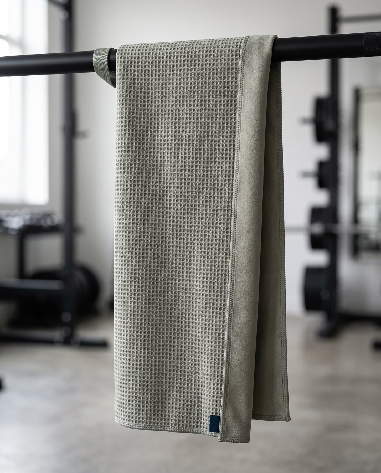 Towel hanging from a rack by its magnetic loop