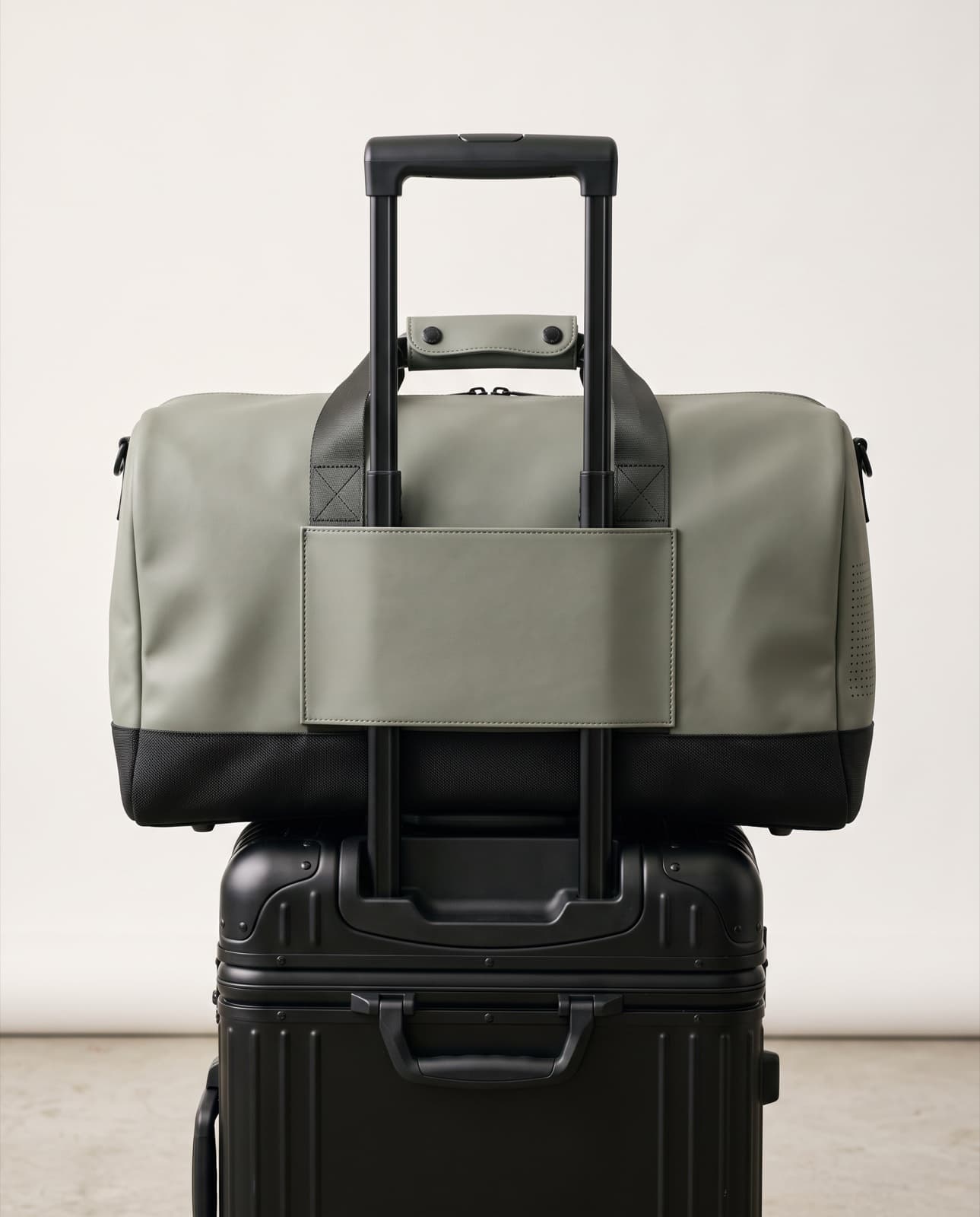 Duffel 40 seated on a carry-on trolley handle